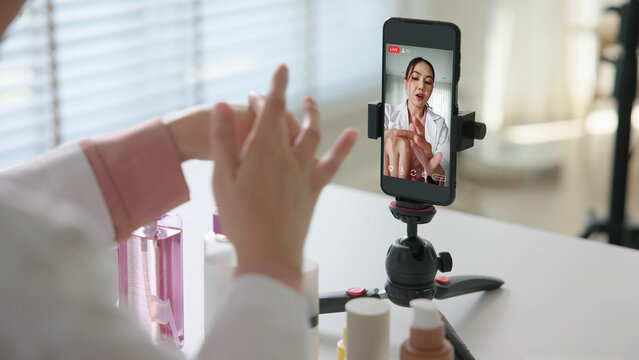 Asia woman people anti aging expert modern health vlogger live advice talk selfie video mobile phone camera. Online digital seller asian small SME store shop owner side hustle filming sell skin care.