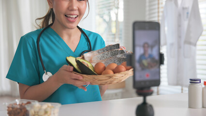 Fototapeta na wymiar Asia woman people anti aging expert modern health care vlogger live advice talk selfie video mobile phone camera. Online diet food weight loss HDL meal plan recipe digital virtual asian coach filming.