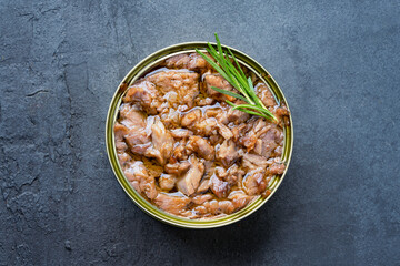 Canned tuna in brine isolated on black background	