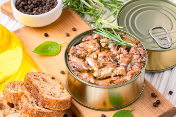 Canned tuna in brine isolated on white wooden background	