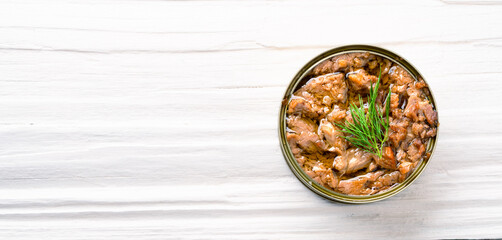 Canned tuna in brine isolated on white wooden background	