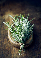 Fresh organic rosemary and curry plant on rustic wooden background