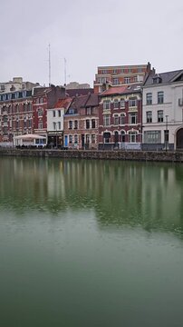 Lille, France - 17 October 2024 - Scenic Reflection of Historic Buildings on a Tranquil Waterway at Le quai du Wault ( Le quai du Wault ) one of the two old ports of Lille, France