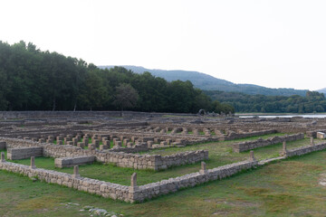 Roman ruins of Aquis Querquennis in Ourense, Spain, near the Limia River. An ancient archaeological site with stone walls, historical heritage, and a picturesque natural landscape.