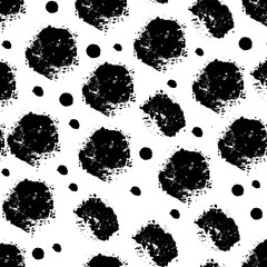 Abstract seamless pattern with black ink splatter and dots on white background.  The design features varying sizes of irregular blotches