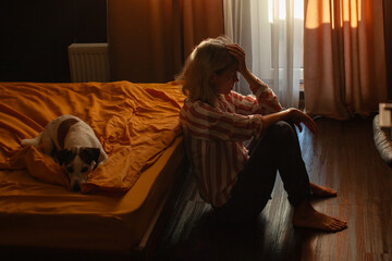 Middle aged woman with feeling Sad and Stressed, Depressed female sitting on Bed in Bedroom