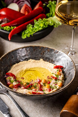 Traditional hummus with olive oil and spices.