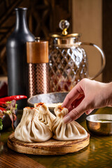 Hand holding Georgian khinkali dumpling.