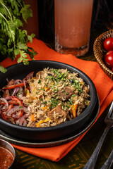 Lamb pilaf with rice, carrots, and herbs.