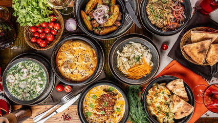 Assorted traditional dishes served on rustic table.