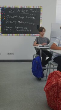 Primary School Students Working on Creative Projects on Computers. Group of Kids Practicing Digital Skills, Studying Programming in Computer Science Classroom. STEM Learning. Dolly Shot. Vertical Shot