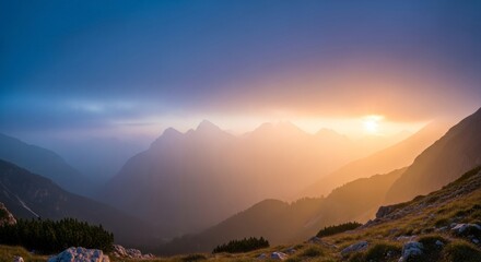A breathtaking vista of a mountain range at sunset, showcasing a hazy golden light illuminating the peaks and valleys.