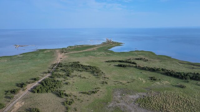 Drone flying towards of Island Sand Spit with Lighthouse