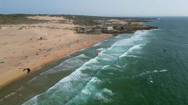 Aerial view of kite surfers in large waves at Guincho beach, in windy Portugal