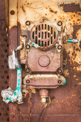 Rusted factory phone on a weathered wall