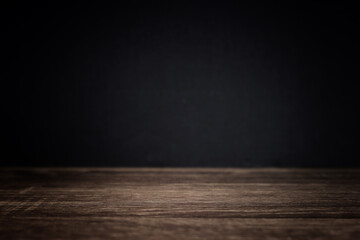 image of wooden table and black textured background.