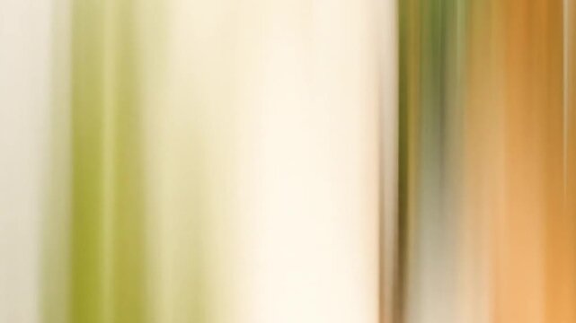 Abstract vertical motion blur of parallel lines in green, orange, and white