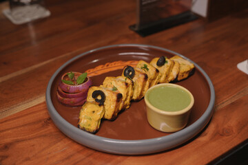 Grilled Paneer Tikka with Mint Chutney and Garnished Onion Rings