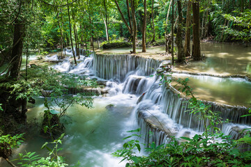 Tropical waterfall surrounded by lush forest at Huay Mae Khamin National Park, Tier 6 Dong Phi Seua, Kanchanaburi, Thailand