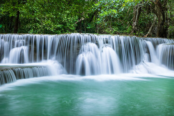 Peaceful tropical waterfall in forest with emerald pool and flowing water, Huay Mae Khamin National Park, Kanchanaburi, Thailand