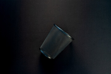 Empty Metal Mesh Pen Holder on Black Desk. Office Organization Theme.