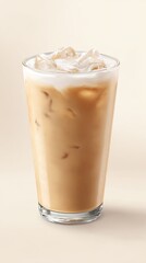 Iced coffee beverage in a clear glass, topped with ice and a layer of creamy foam, set against a light beige background