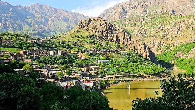 A peaceful river winds through Selin village, embraced by lush hills and majestic mountains, revealing nature&rsquo;s gentle harmony and rural charm. 📍 Selin, Hawraman Takht