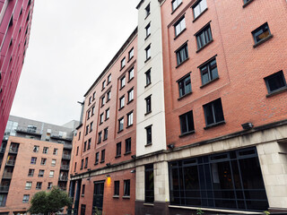 Fototapeta premium Modern brick-and-glass residential buildings in Manchester, UK, highlighting urban architecture