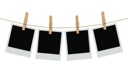 Four blank instant photos hanging from a string with wooden clips ready for your memories and creative projects now