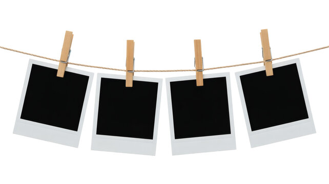 Four blank instant photos hanging from a string with wooden clips ready for your memories and creative projects now