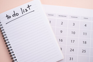 Notepad with to-do list and calendar on color background. Planning and design concept.