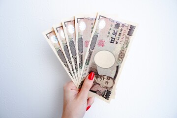 日本のお札と女性の手