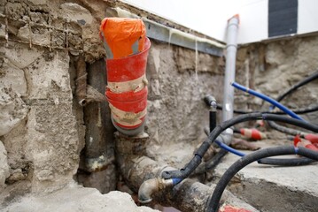 The plumbing work is currently in progress, showcasing exposed pipes and a bare floor in a bathroom renovation project