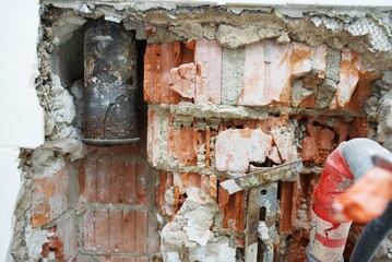 The plumbing work is currently in progress, showcasing exposed pipes and a bare floor in a bathroom renovation project