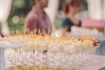 Festive dessert display at a cheerful outdoor gathering in the warm afternoon sun, showcasing a...