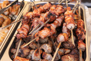 Metal tray with freshly grilled shish kebab on skewers