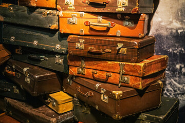 antique suitcases from the last century stacked on top of each other. Migration and refugee. World...