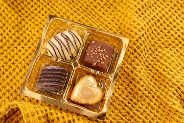 Assorted Chocolate candy brown white and dark in the shape of heart. Box with delicious set of many different chocolate candies.