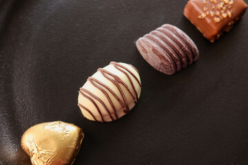 Assorted Chocolate candy brown white and dark in the shape of heart. Box with delicious set of many different chocolate candies.