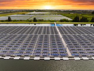Floating solar panels at renewable electrical power plant for producing clean electric energy. Concept of sustainable photovoltaic electricity on water surface with zero emission