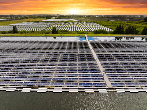 Floating solar panels at renewable electrical power plant for producing clean electric energy. Concept of sustainable photovoltaic electricity on water surface with zero emission
