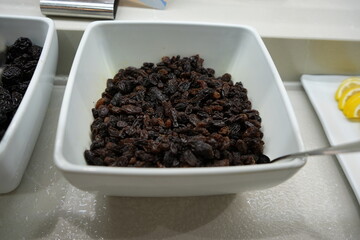 Raisins in a bowl displayed on a breakfast buffet table in a hotel in Benidorm, Spain