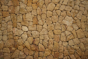 Rustic stone wall texture featuring Mediterranean architecture in Benidorm, Spain.