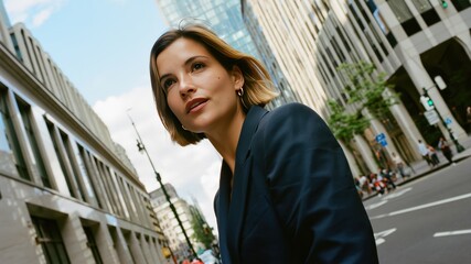 Business, thinking and woman in city, travel and decision with buildings, urban town and ideas. Below, person and entrepreneur in street, confidence and commute with choice, thoughtful and wonder