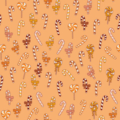 Lollipop canes, lollipops, sweets. Halloween pattern seamless orange wallpaper.
