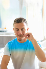 A portrait of a man with moustache in his late 30's.