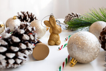 Festive Christmas scene with golden ornament and pine cones