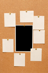 Blank paper notes and an empty photo are pinned to a cork board. The concept of detective investigation or a webinar.