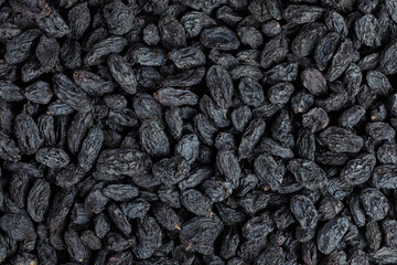 black raisins as a background. Top view. Flat lay
