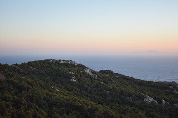 Sunset at Monolithos castle, Rhodes island, Greece. Sightseeing spots on Rhodos. View from the ruin Monolithos Castle. Holidays and travel to Rhodes Island. Rhodes seascapes and nature. 